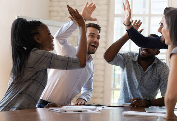 motivated employees standing at desks