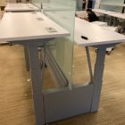 sit/stand trading desks in office adjusted to different heights