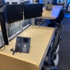 trading office desks adjusted to sit and stand heights side view