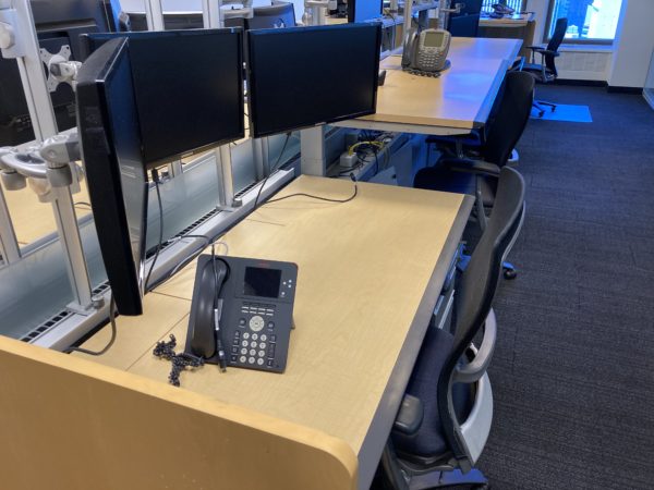 trading office desks adjusted to sit and stand heights side view