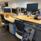 trading office desks adjusted to sit and stand heights