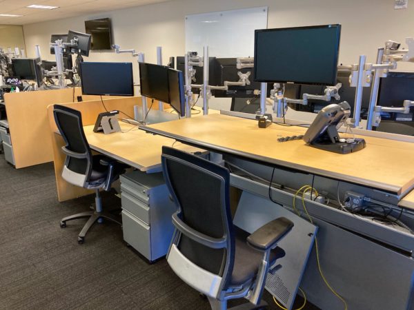 trading office desks adjusted to sit and stand heights