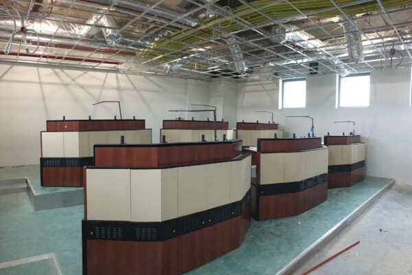 Evans Control room under construction with wood-accented consoles and open ceiling grid