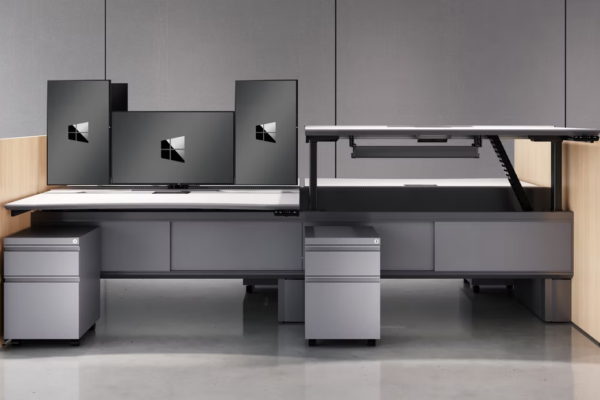 LaCour Hybrid-height trading desks with wood sides, black surfaces, and monitors.