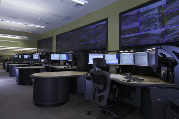 Evans Modern traffic operations center with curved consoles and wall-mounted video walls.
